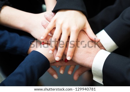 Closeup of pile of hands of business partners