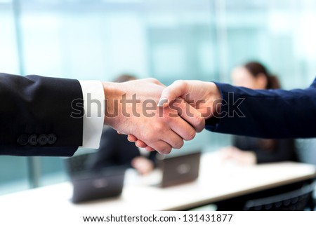 Business handshake and business people at the office