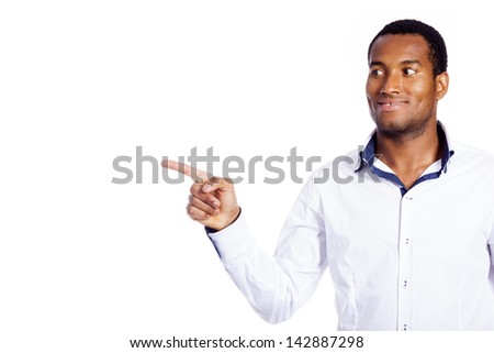 Happy smiling black man pointing at copy space, isolated on white background