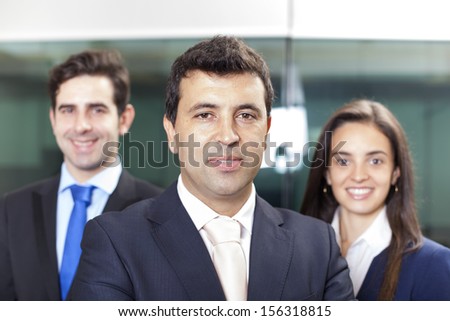 Confident businessman leader on the foreground of his team