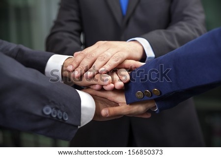 Business team showing union with their hands together forming a pile