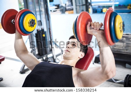 Strong man training with weights in the gym