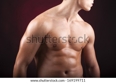 Cropped image of a beautiful man torso against black background