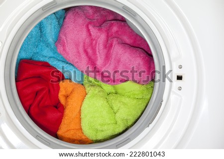 Wash machine with colored clothes inside