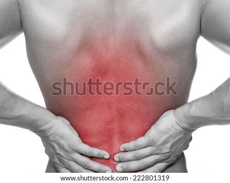 Rear view of a young man holding his back in pain, isolated on white background