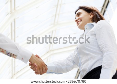 Smiling businesswoman giving a handshake
