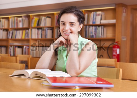 Cute female student studying at the university library