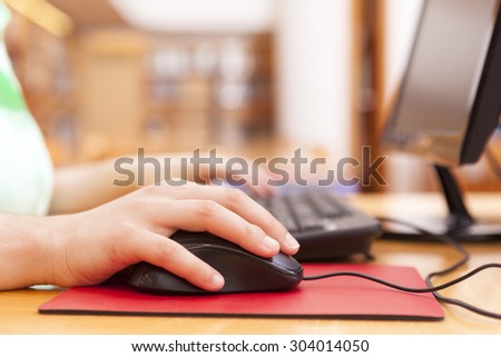 Close up of a woman using the computer at the university