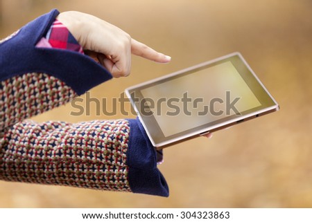 Woman finger pointing to a tablet computer