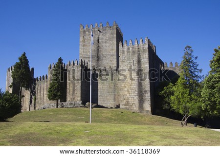 Guimaraes castle in the north of Portugal  and surrounding park against a clear blue sky