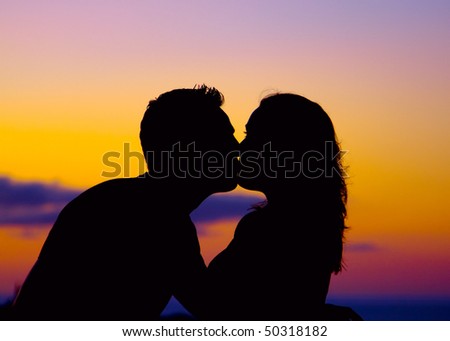 couple kissing sunset. couple kissing at sunset