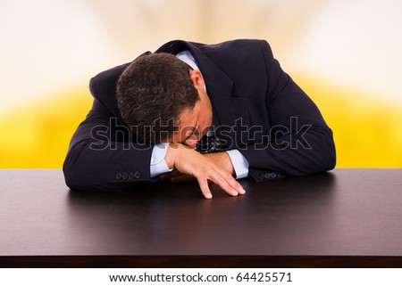 Tired mature business man sleeping on the desk at the office