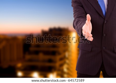A businessman with an open hand ready to seal a deal at the office