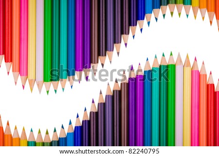Color pencils crayons in arrange in color wheel colors on white background