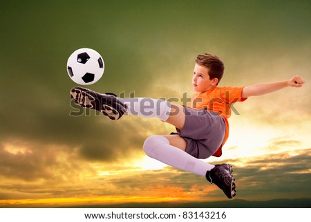 Image of young soccer player doing flying kick with ball