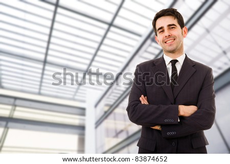 Portrait of an handsome smiling businessman at a modern office bulding
