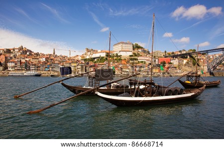 panorama old Porto river Duoro, vintage port transporting boats, old town, town of Gaia and famous bridge Ponte dom Luis, Portugal