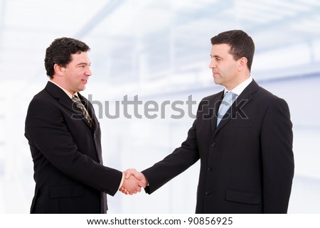 Business people shaking hands, coming to an agreement in the office