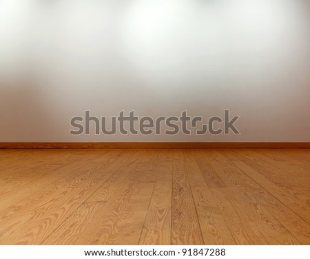 Empty White Wall With Spot Lights And Wooden Floor