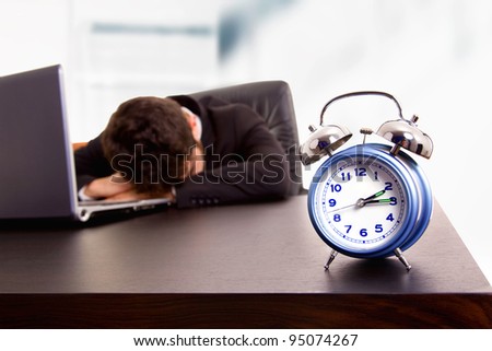 young business man sleeping on the laptop at his office