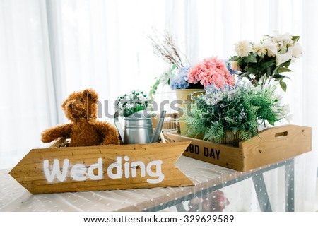 Beautiful decoration of garden with flower box, teddy bear and watering can. (Vintage tone color)
