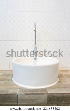 White sink and chrome faucet with white tiles