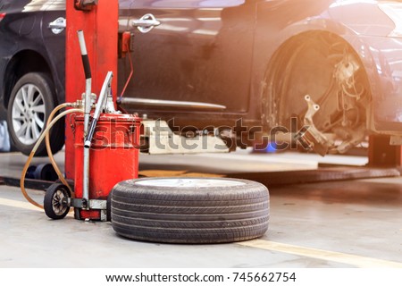 closeup tire and car parking repair garage with soft-focus in the background and over light