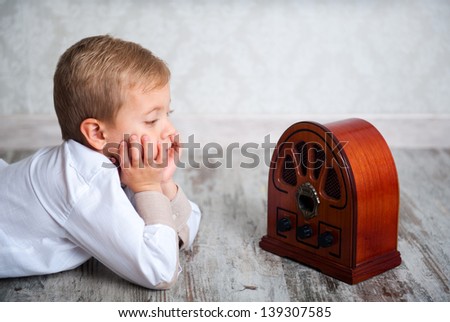 Cute boy of five years listening to Vintage Radio