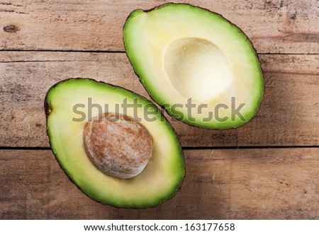 Ripe avocado on a wooden board in the studio