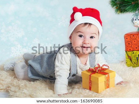 Sweet girl with a gift in a red cap