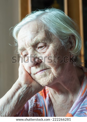 Pretty old grandmother sitting alone thinking cute