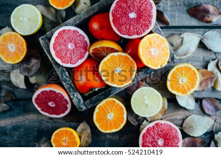 Fresh fruits. Mixed fruits background. Healthy eating, dieting. Background of healthy fresh fruits. Fruit salad - diet, healthy breakfast. pomegranate, persimmon, tangerine, banana, lemon