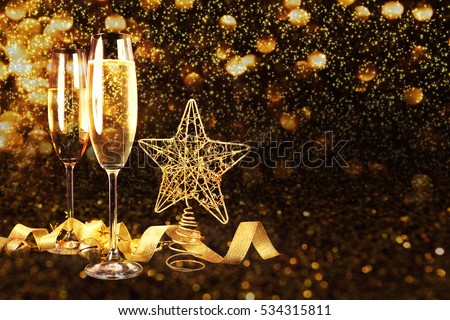 Two glasses of champagne over blur spots lights background. Celebration concept, free space for text