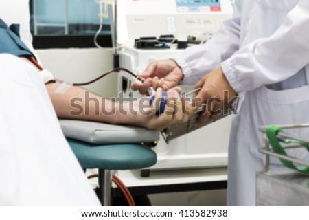 technician take a blood sample to test the protein levels ,in Blood Plasma Donation process, blurred background