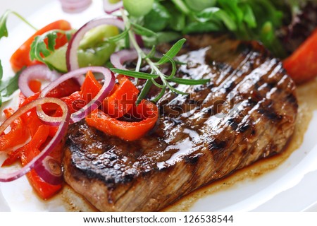 Grilled steak meat with salad from baked pepper