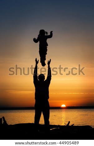 Father throws his infant child into the air