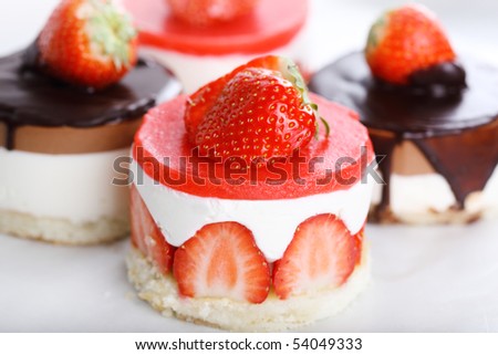 Assorted cakes with fresh strawberries and chocolate