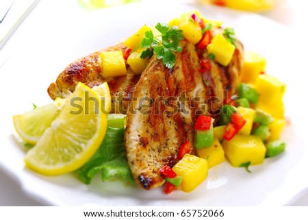 Grilled chicken breast with fresh mango salsa, soft focus