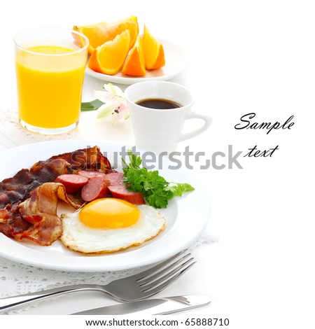 Breakfast with bacon, fried egg and orange juice on white isolated background(With sample text)