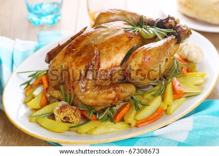 Whole roasted chicken with vegetables on a white plate