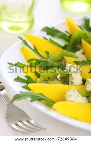 Fresh salad with mango, kiwi and blue cheese