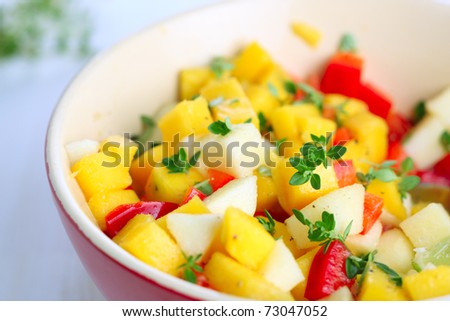 Fresh salad with mango, red pepper, apple and lemon thyme
