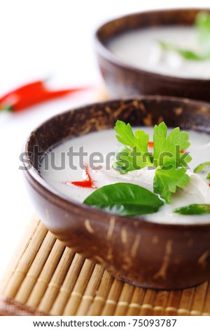 Thai chicken and coconut milk soup on white isolated background