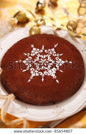 Chocolate truffle cake decorated with snowflake