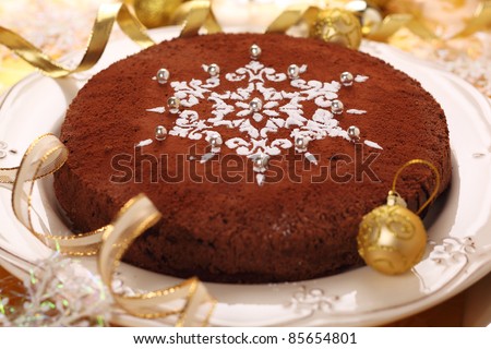 Chocolate truffle cake decorated with snowflake