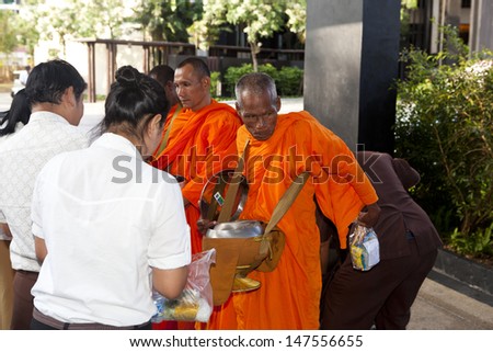 BUDDHIST MONKS,PHUKET, THAILAND - MARCH 22: Buddhist monks seeking Alms at western hotels, Thailand, March 22nd, 2013, Phuket, Thailand. Alms for the poor