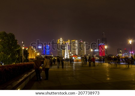 SHANGHAI, CHINA - 28th MARCH 2014: The Bund is a great place to people watch, the city scape comes alive at night