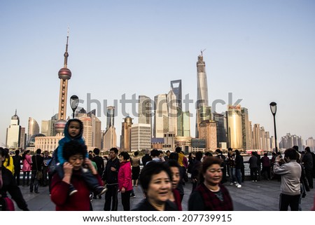 SHANGHAI, CHINA - 28th MARCH 2014: The Bund is a great place to people watch on the banks of the river, modern one side and European architecture the other.