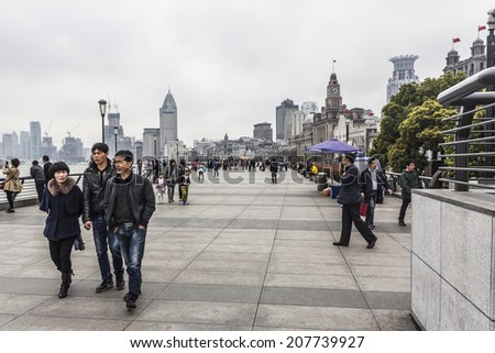 SHANGHAI, CHINA - 28th MARCH 2014: The Bund is a great place to people watch on the banks of the river, modern one side and European architecture the other.