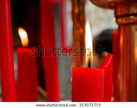 The flame on red candle at the Chinese temple.